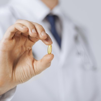 doctor hand showing one capsule