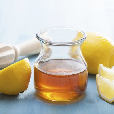 honey and lemon over blue background