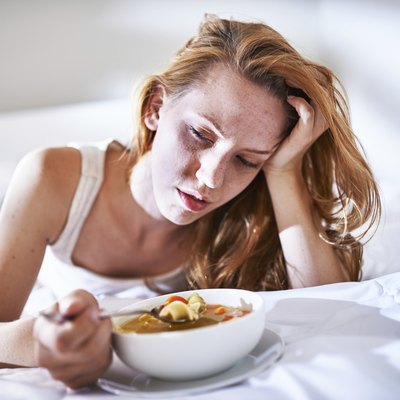 eating chicken noodle soup in bed while sick