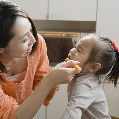 Mother Brushing Daughter's Teeth