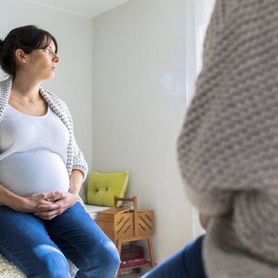Pregnant woman reflected on a mirror