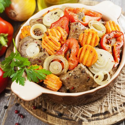 Liver fried with vegetables in the ceramic pot