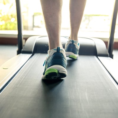 Young men walking on treadmill