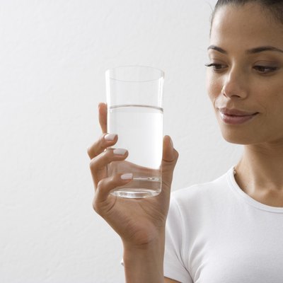 Young woman holding glass of water