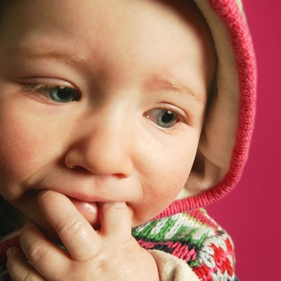 A baby with fingers in mouth