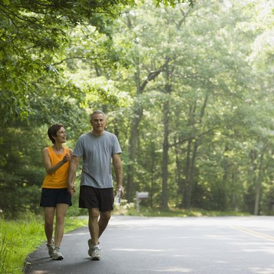 Happy couple walking along road together