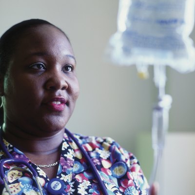 Female nurse adjusting a drip