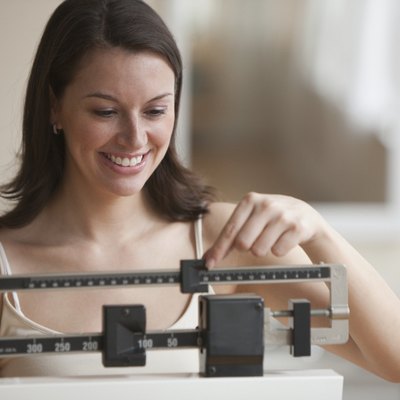 Close up of a woman weighing herself