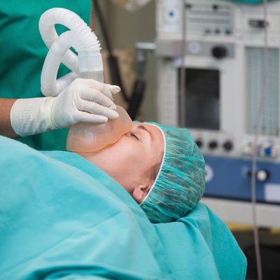 Nurse putting an oxygen mask