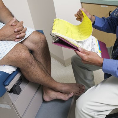 Male patient sitting on an examination table in a doctors office