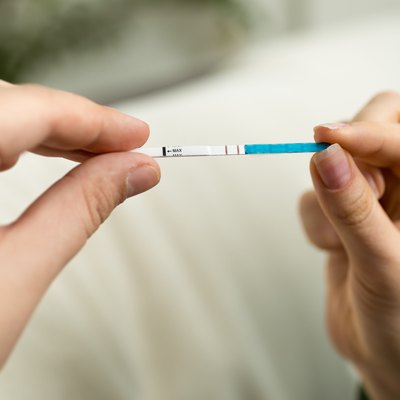 Closeup shot of woman holding positive pregnancy test