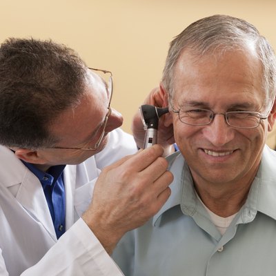 Audiologist doing an ear canal inspection