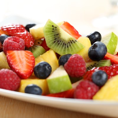 cut fruit salad on white plate