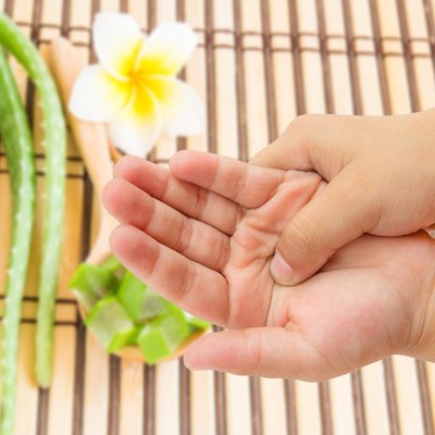 hand pain with blurred aloe vera background