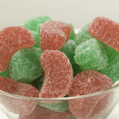 Green and red sugared candies in glass bowl