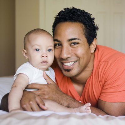 Father and son on a bed