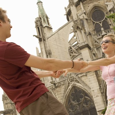 France, Paris, Notre-Dame, couple holding hands, smiling