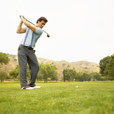 Golfer preparing to drive ball