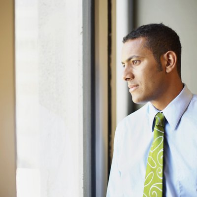 Businessman looking through window