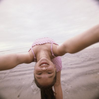Girl bending over backwards on the beach