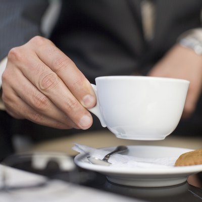 Hand holding coffee cup