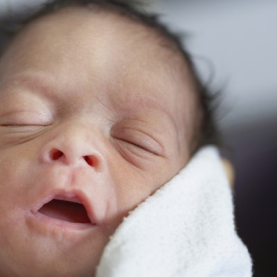 Close up of newborn African baby sleeping