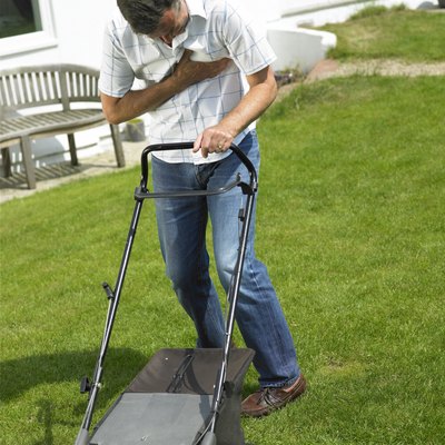 Man with chest pain mowing lawn