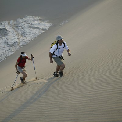 Man and woman hiking through desert