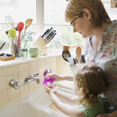 Mother and daughter washing hands