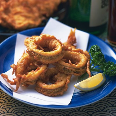 Sliced fried squid on plate, high angle view, differential focus