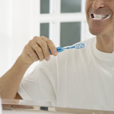 Mature man brushing his teeth