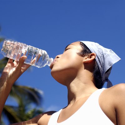 Woman drinking from water bottle