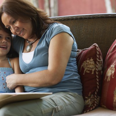 Hispanic grandmother reading to granddaughter