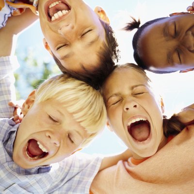 low angle view of children standing in a huddle with their mouth open