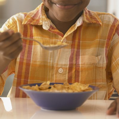 African boy eating cereal