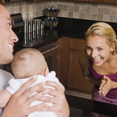 Hispanic mother smiling at baby