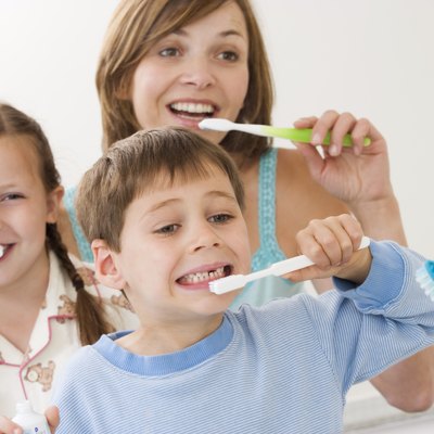 Mother and children brushing teeth