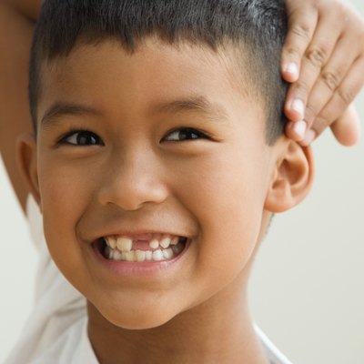 Young boy showing off the gap in his teeth