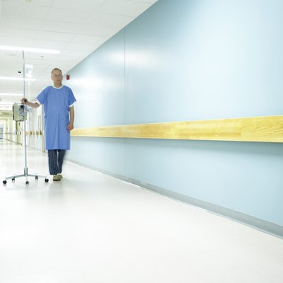 Male patient walking with an IV drip stand