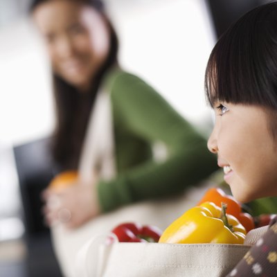 Side view of girl with bag of produce