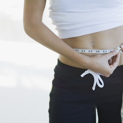 Woman measuring waistline