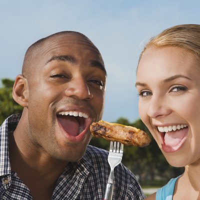Multi-ethnic couple eating from same fork