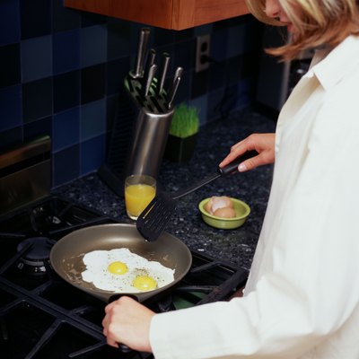 Woman frying eggs