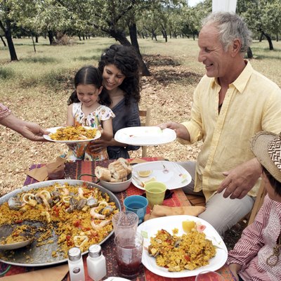 family eating paella outdoors