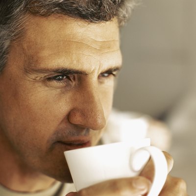 close-up of a mature man drinking a cup of tea