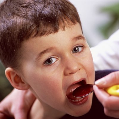 Boy taking liquid medicine