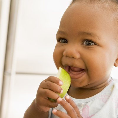 Young girl eating apple indoors