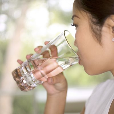 Close-up profile of a woman drinking water.