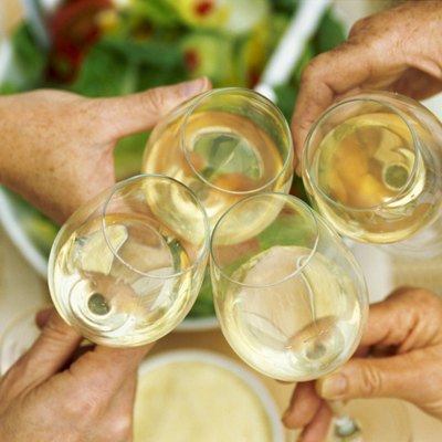 Elevated view of four glasses of white wine held together