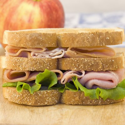 triple decker sandwich on cutting board